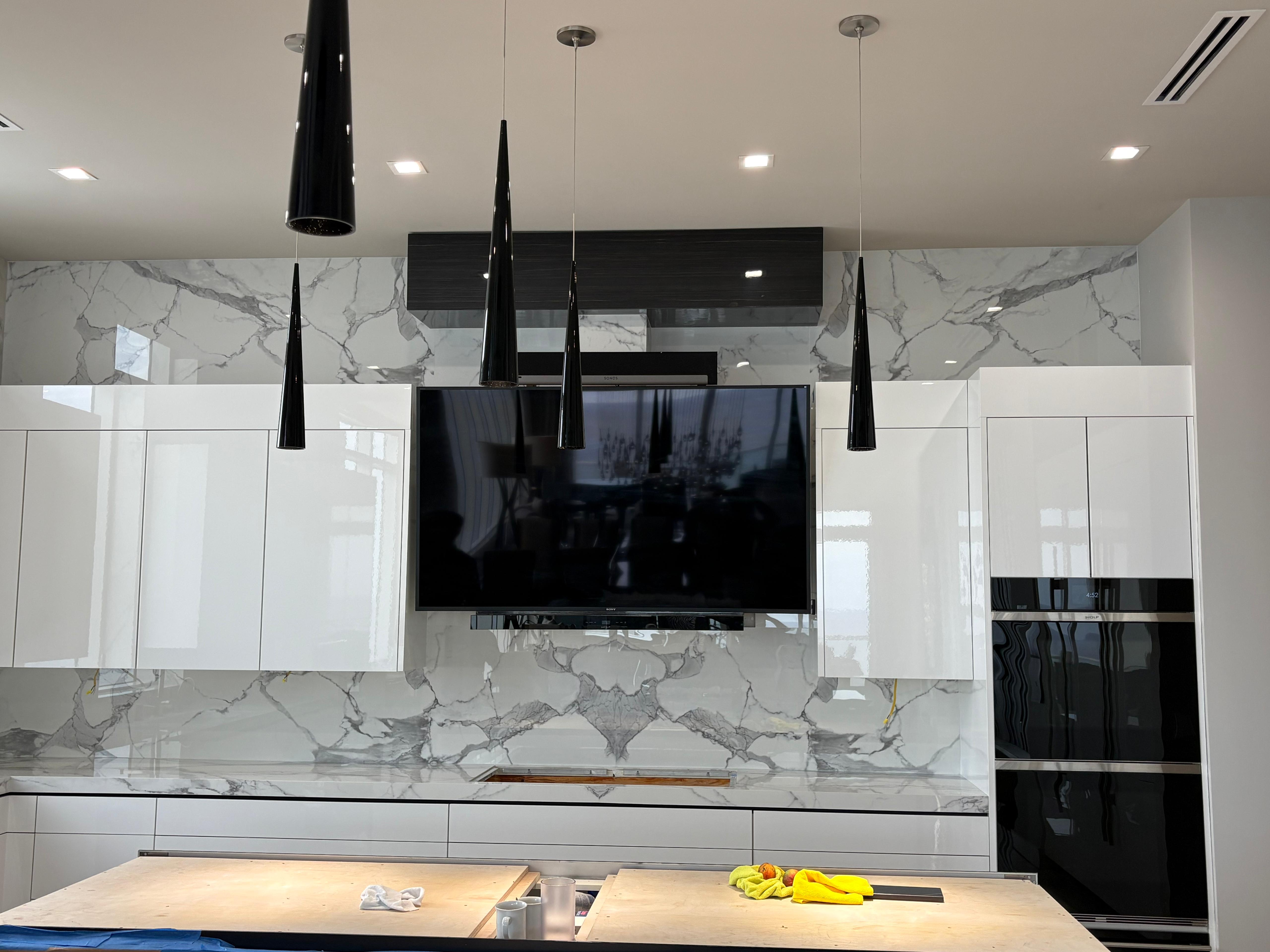 Dramatic book-matched veining behind a floating media wall