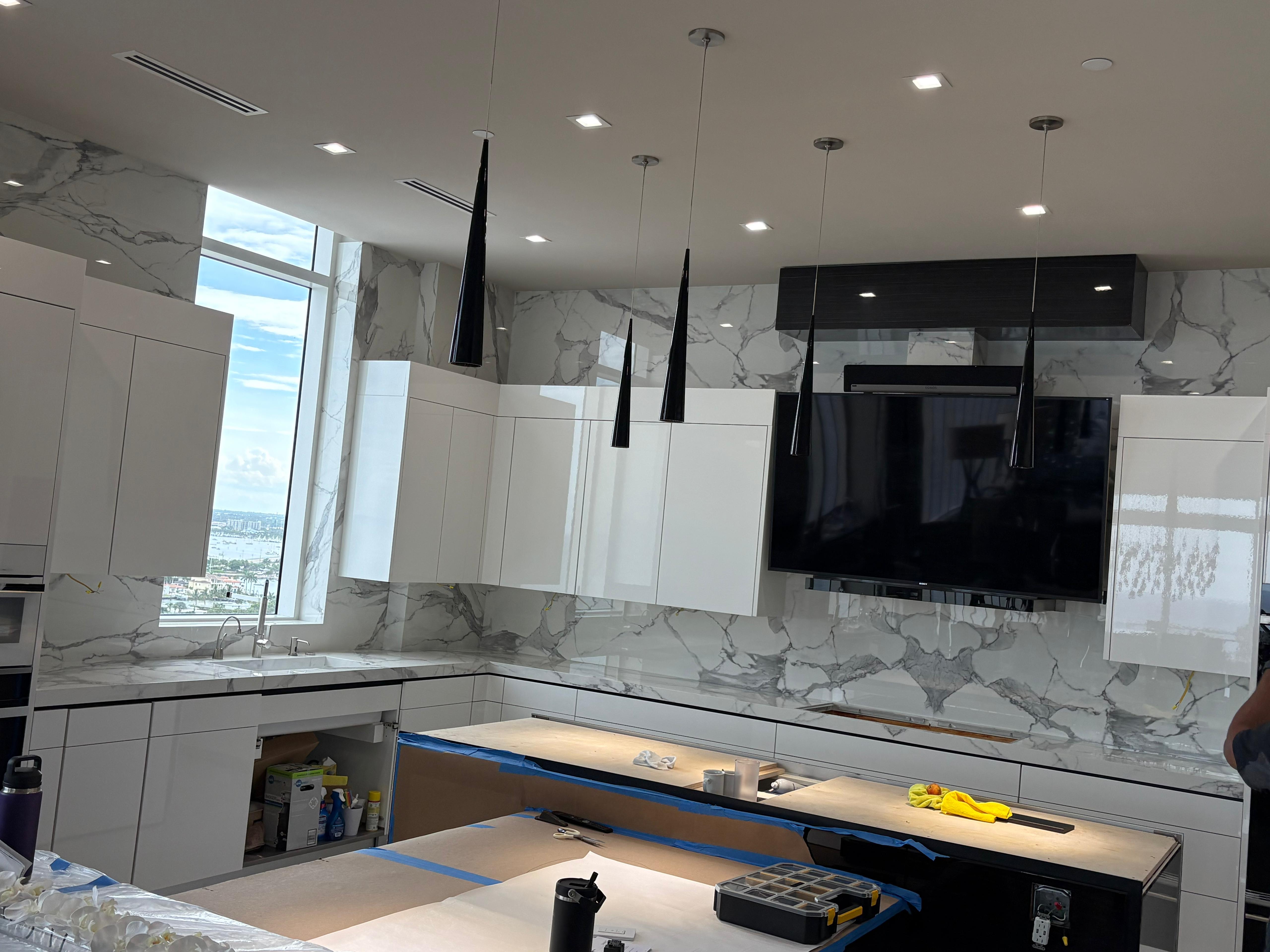 Cream quartz countertop with induction cooktop and ocean light