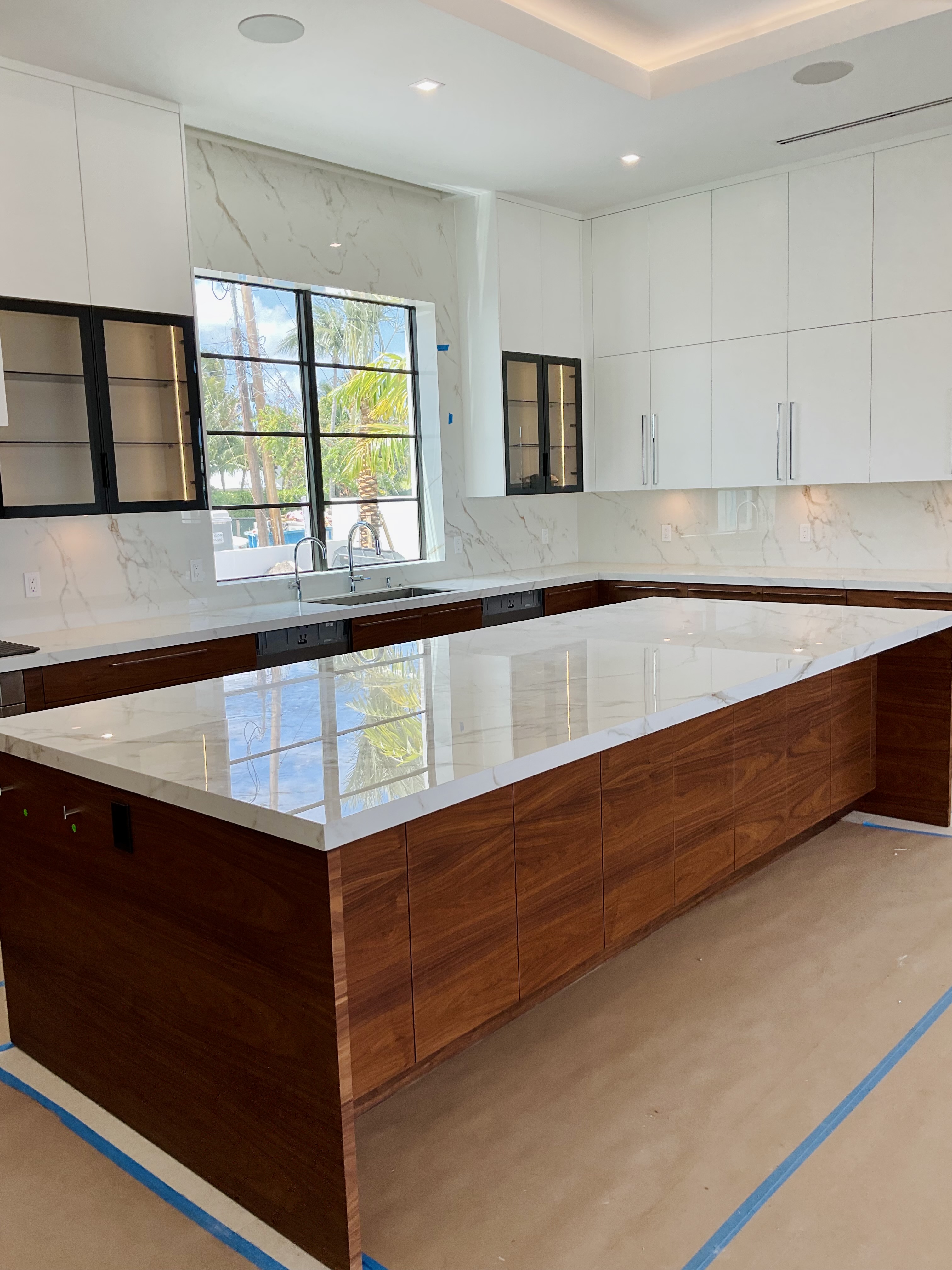 Walnut island with a Calacatta marble waterfall countertop